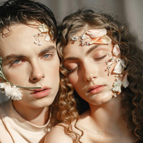 pexels-photo-8770883-8770883 Elegant portrayal of two models with floral adornments on their faces, showcasing beauty and creativity.